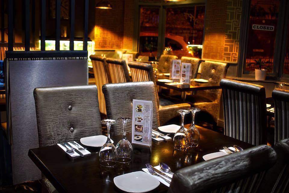 Tables laid for dinner by the front window